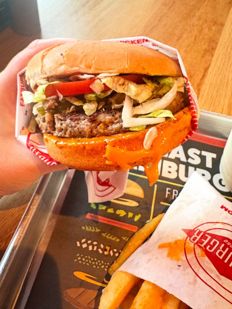 Vegan Impossible Burger at Fatburger featuring dairy-free cheddar cheese, fresh vegetables, and thick-cut fries at a Manteca location.