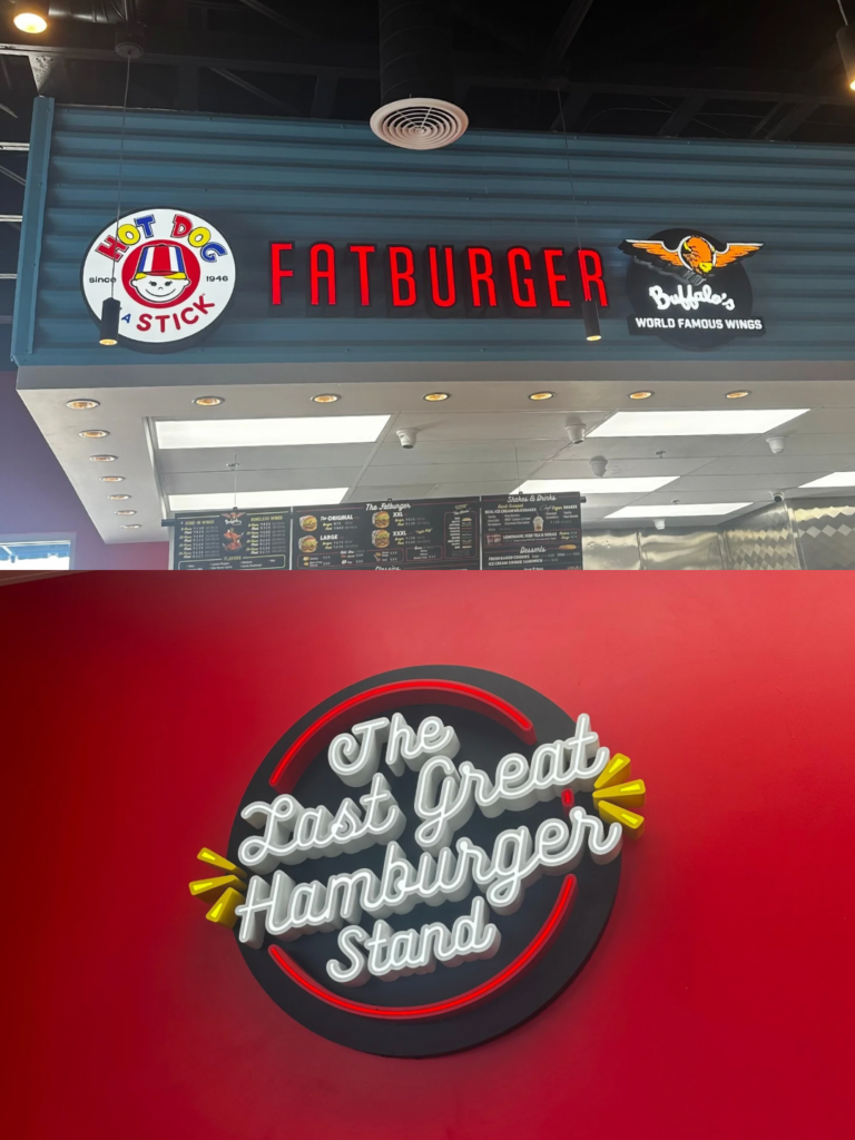 Interior of Fatburger restaurant in Manteca with illuminated Fatburger and Hot Dog on a Stick signs.