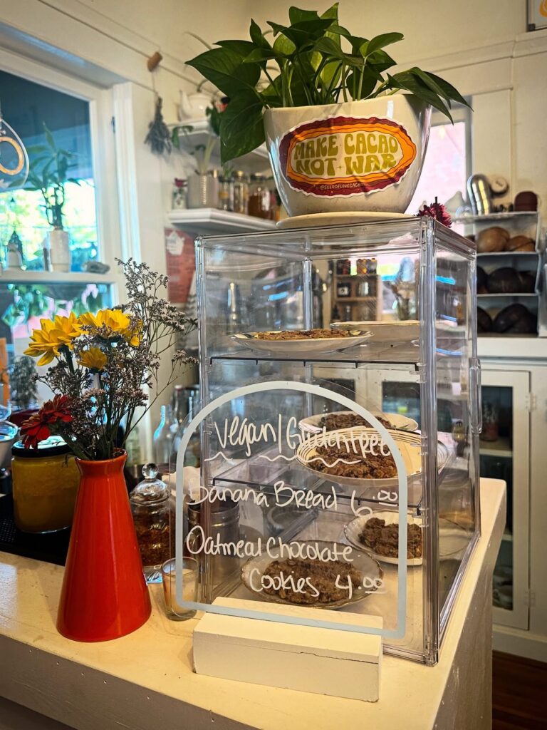 Bakery display case filled with fresh vegan and gluten-free pastries and baked goods inside Alchemist Café & Elixir Bar in Modesto.