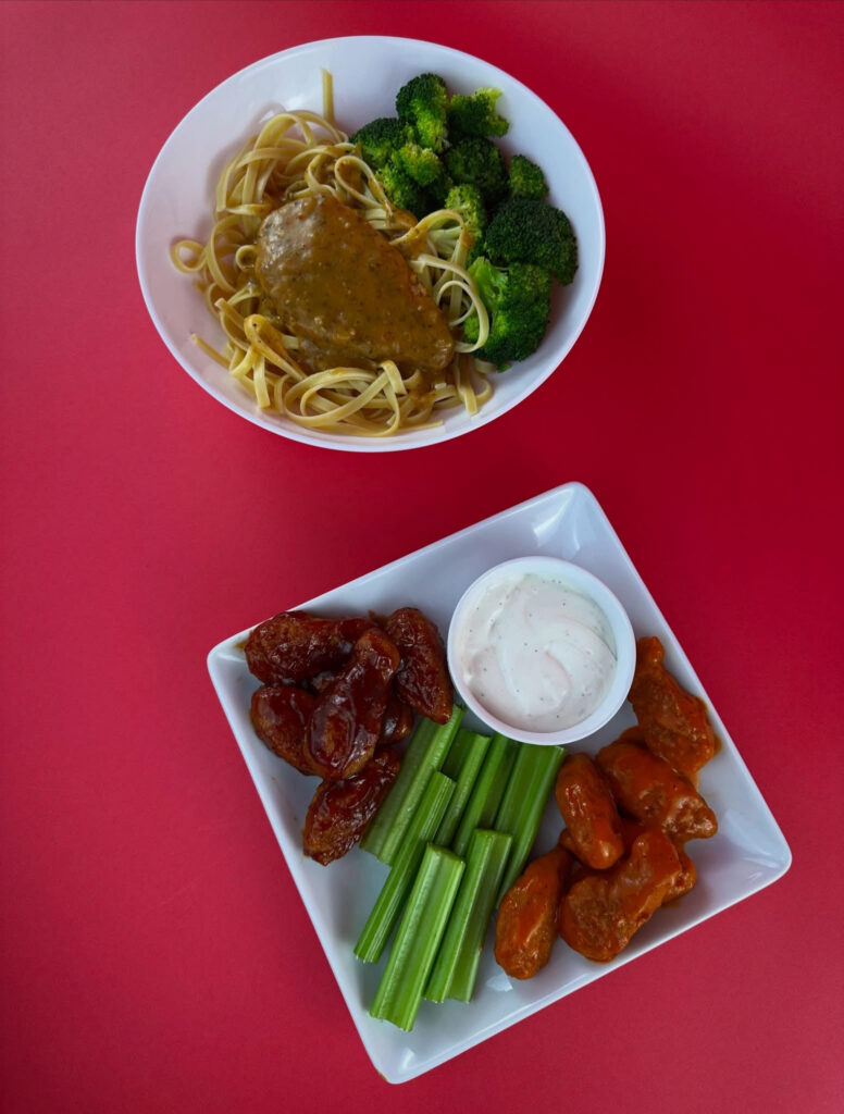 MorningStar Farms Chik'n Breast pasta bowl and Buffalo and BBQ Chik'n Wings served together on a pink background.
