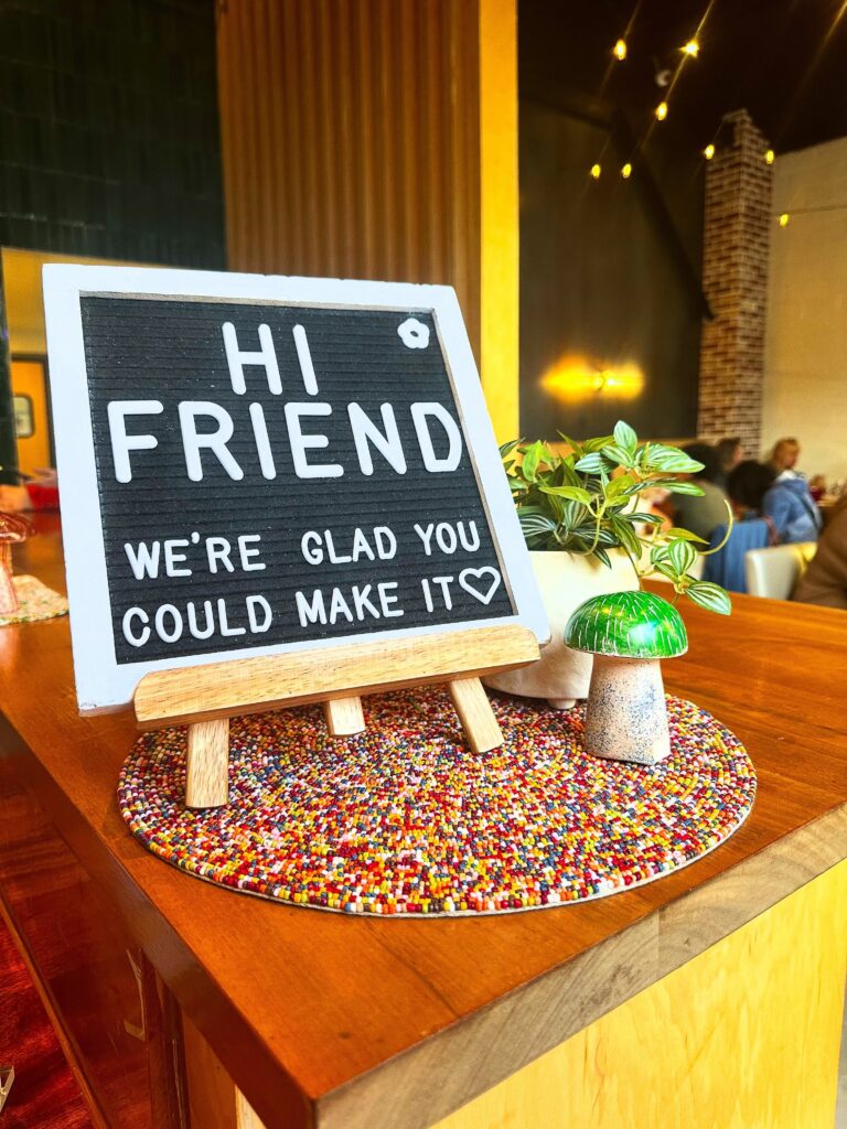 Fungi Foods bar and cash wrap display with a Hi Friend conversation card and colorful mushroom-themed decor.