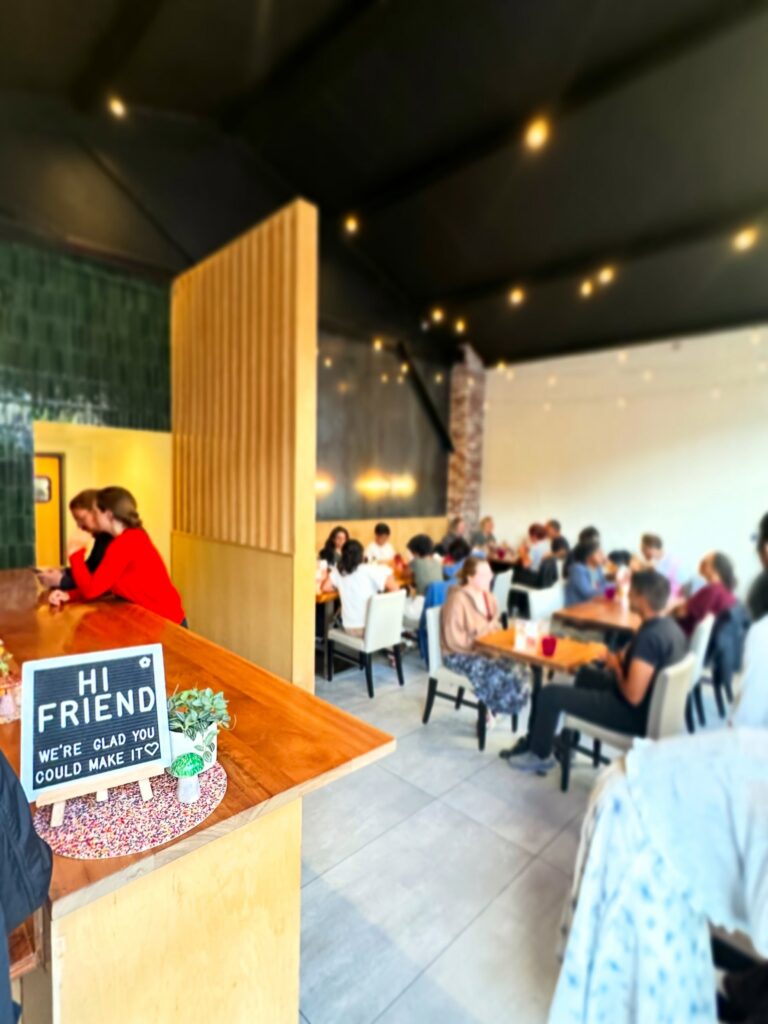 Interior of Fungi Foods restaurant in Oakland with dining tables and patrons