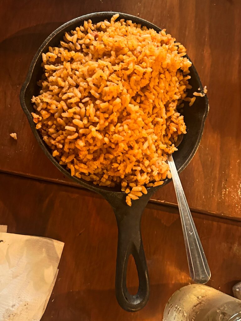 Skillet of arroz con tomate served family-style during the September Vegan Roast dinner.
