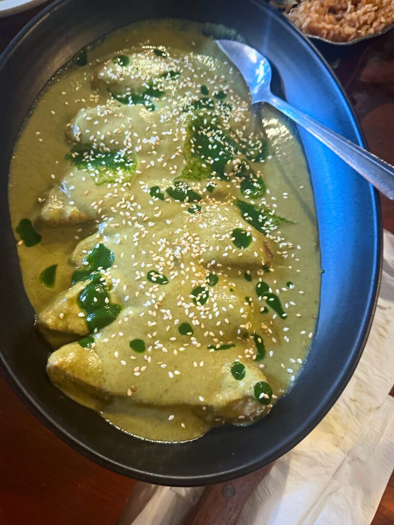 Gardein Chick’n covered in creamy mole verde and topped with sesame seeds and green oil.