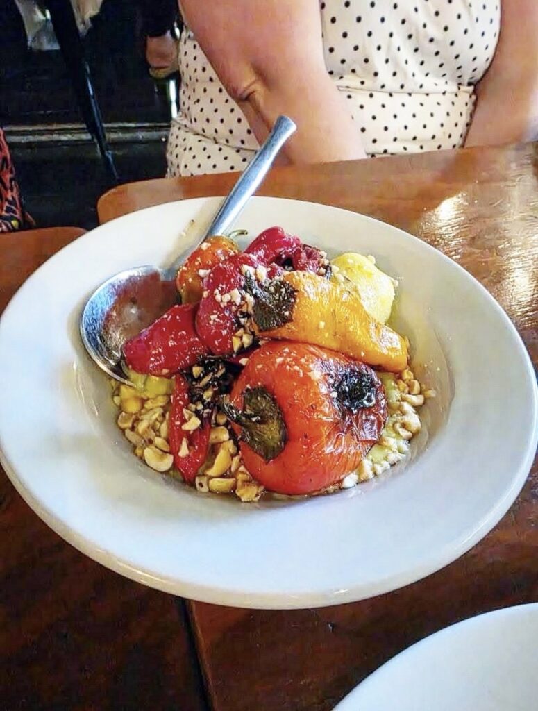 Colorful charred Jimmy Nardello pepper salad served as a course at Cast Iron Trading Co.’s Vegan Roast.
