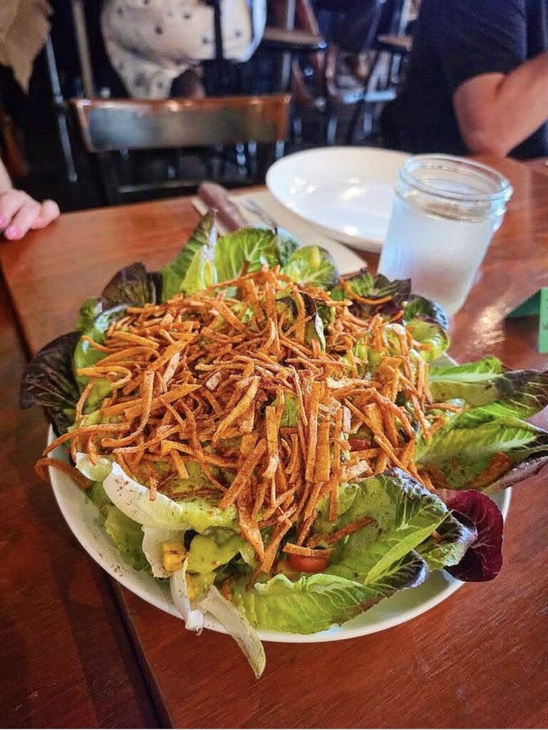 Overhead view of the Sweet Gem Salad with crispy tortilla strips at the September Vegan Roast in Stockton.