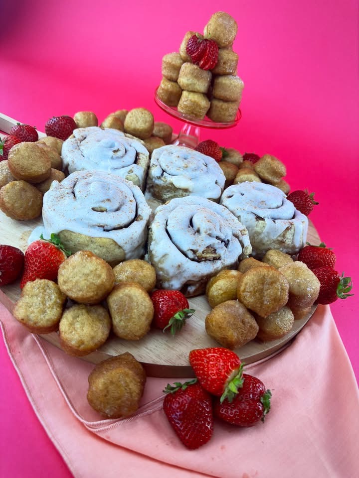 Platter of vegan gluten-free cinnamon rolls and glazed donut holes from Gluten Gone Goodies with fresh strawberries.