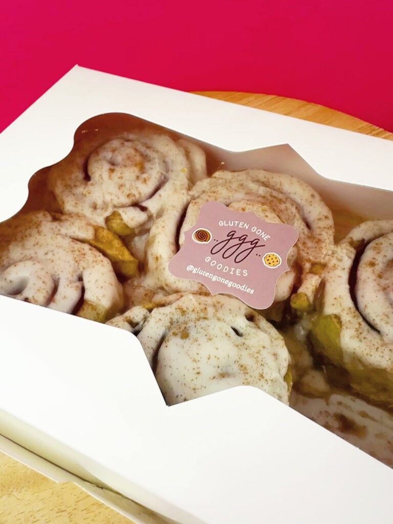 Box of vegan gluten-free cinnamon rolls from Gluten Gone Goodies with branded bakery sticker.