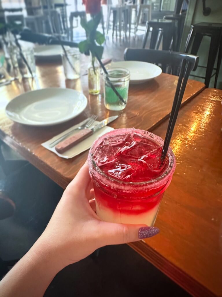 Layered red and white house margarita served before the Vegan Roast dinner at Cast Iron Trading Co.