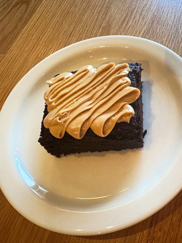 Vegan chocolate cake with frosting at Penny University Coffee in Modesto