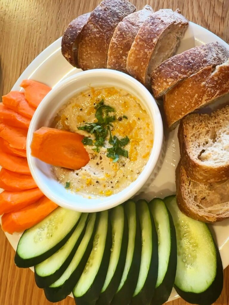 White bean hummus with sourdough crostini and fresh vegetables at Penny University Coffee in Modesto