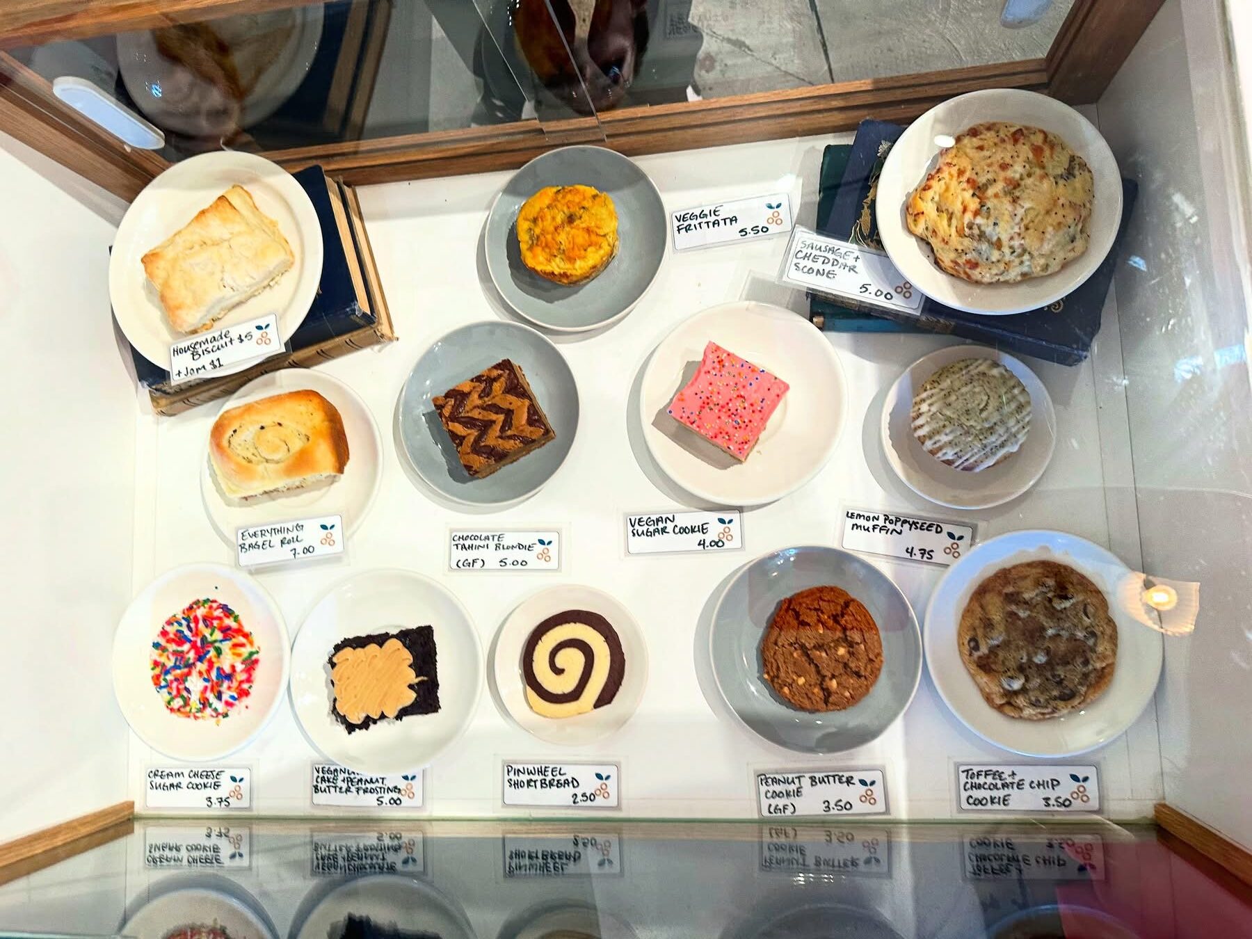Bakery case at Penny University Coffee with vegan sugar cookie bar and vegan chocolate cake