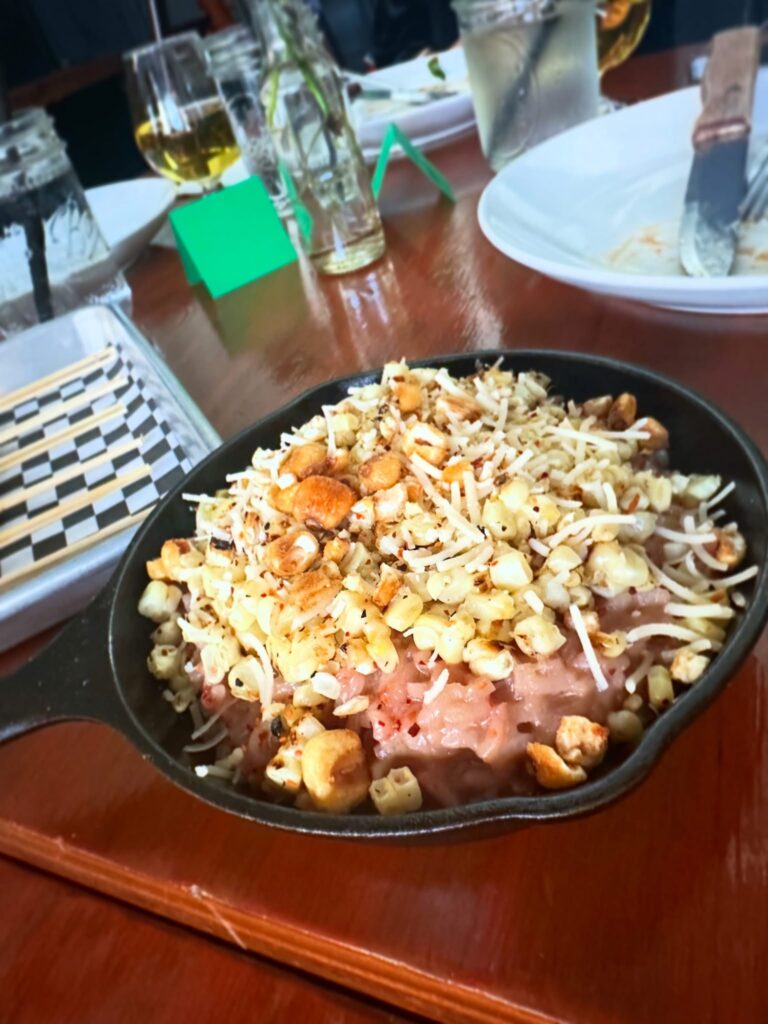 Creamy esquites-inspired corn risotto topped with grilled corn, crispy corn, vegan parmesan, and seasonings.