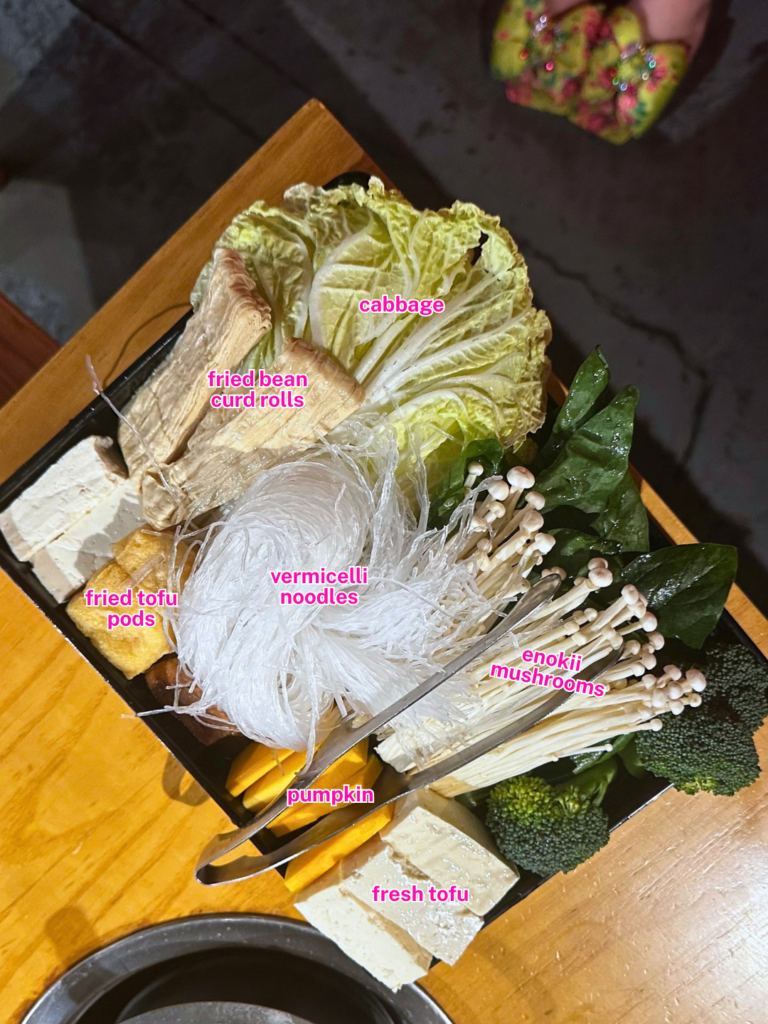 MUMU Hot Pot vegan platter with cabbage, fried bean curd rolls, fried tofu pods, vermicelli noodles, enoki mushrooms, pumpkin and fresh tofu