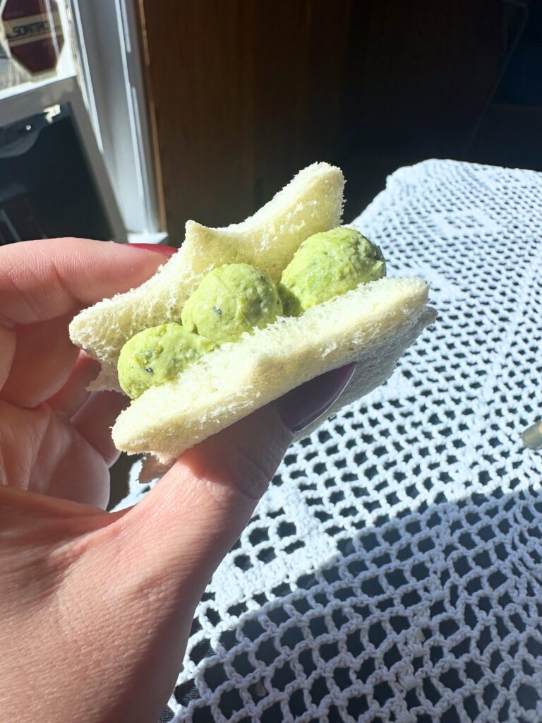Elegant-shaped vegan cucumber and cream cheese finger sandwich from the Vegan Dollhouse afternoon tea.