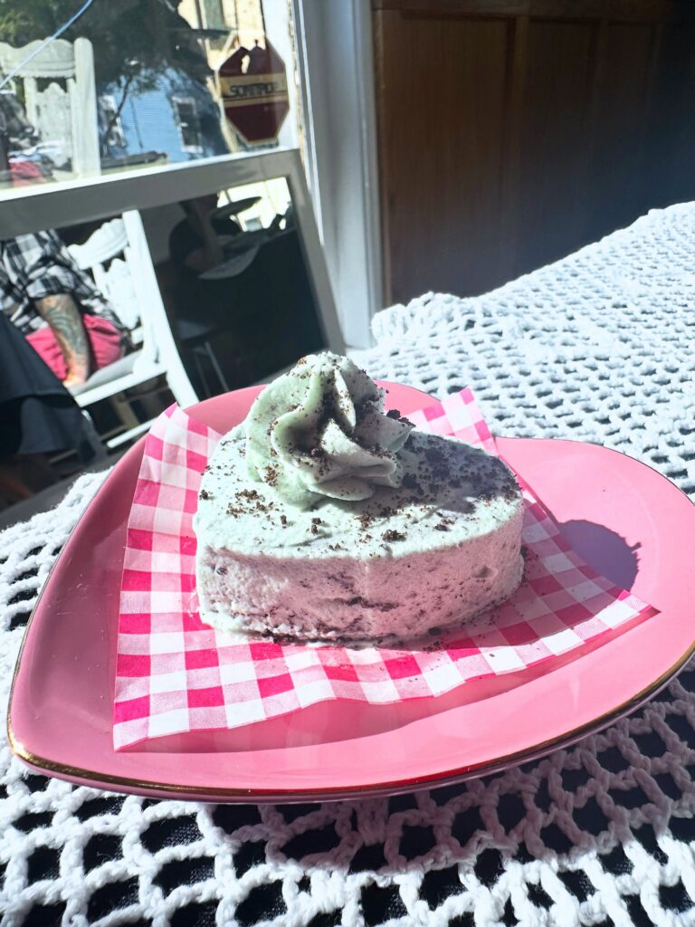 Vegan mint cookies and cream cake with mint frosting and cookie crumbs.