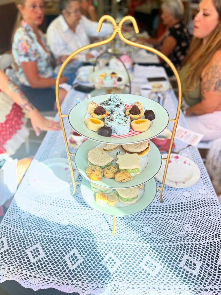 Three-tier vegan afternoon tea stand filled with sweet and savory treats at Lady Bird Tea House.