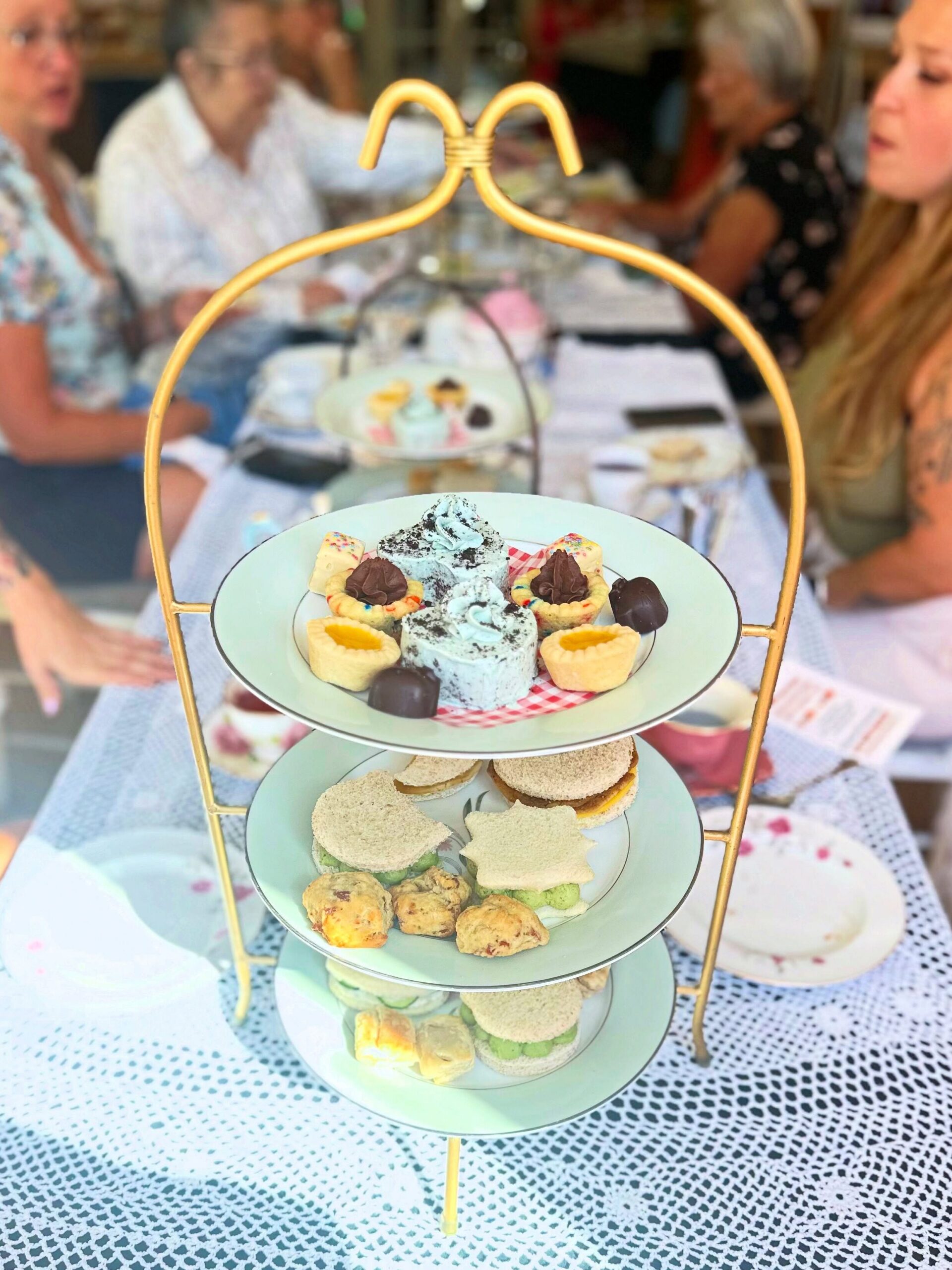 Three-tier afternoon tea stand filled with vegan sandwiches, savory bites, and desserts at the Vegan Dollhouse tea party at Lady Bird Tea House in Fair Oaks.