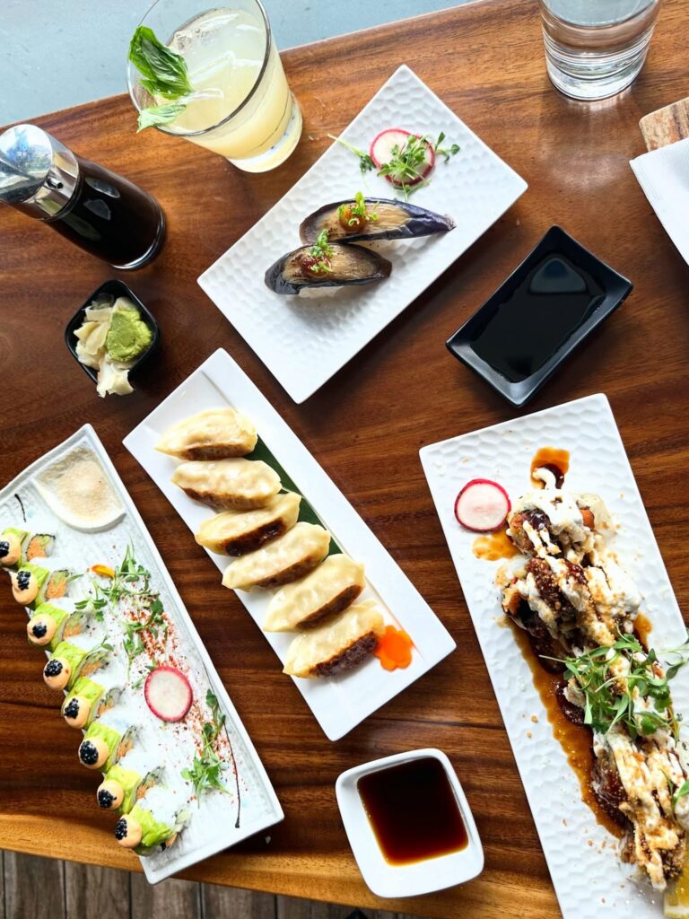 Vegan sushi, gyoza, eggplant nigiri and cocktails spread across the table at Tane Vegan Izakaya