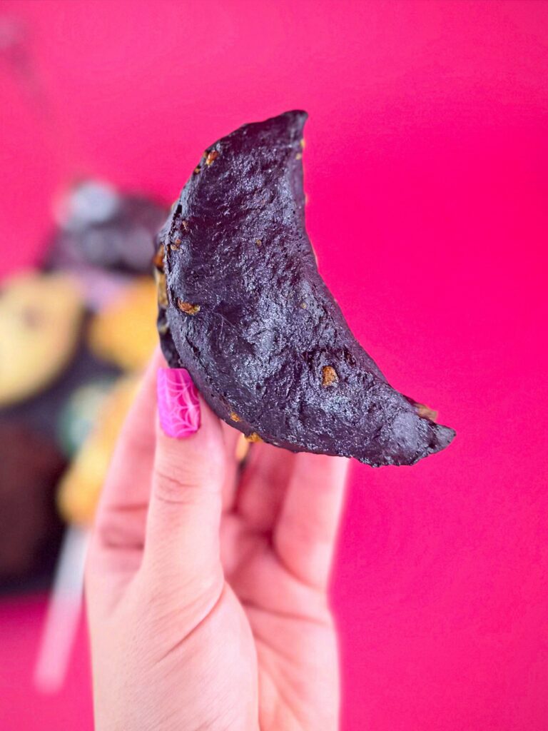 Black savory gibbous moon scone with vegan bacon and cheddar from Vegan Dollhouse.