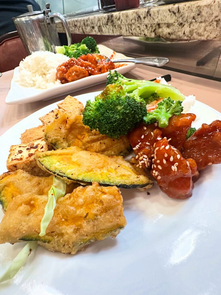 Plate of crispy salt and pepper tofu, vegan sesame chicken, white rice, and broccoli at Veggie Lee in Hayward