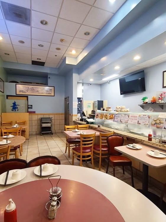 Interior dining room of Veggie Lee in Hayward with tables, chairs, and a counter