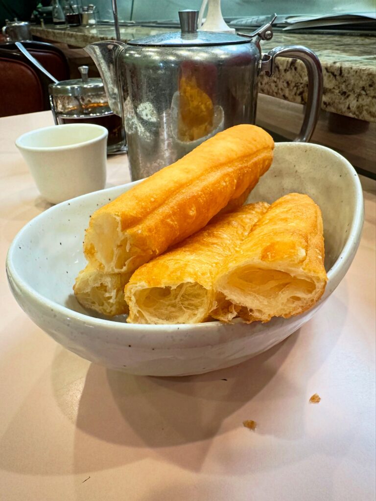 Golden fried vegan Chinese donuts served in a white bowl at Veggie Lee in Hayward, California